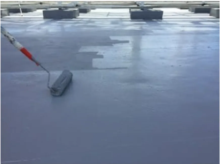 Liquid waterproofing being rolled over a prepared substrate