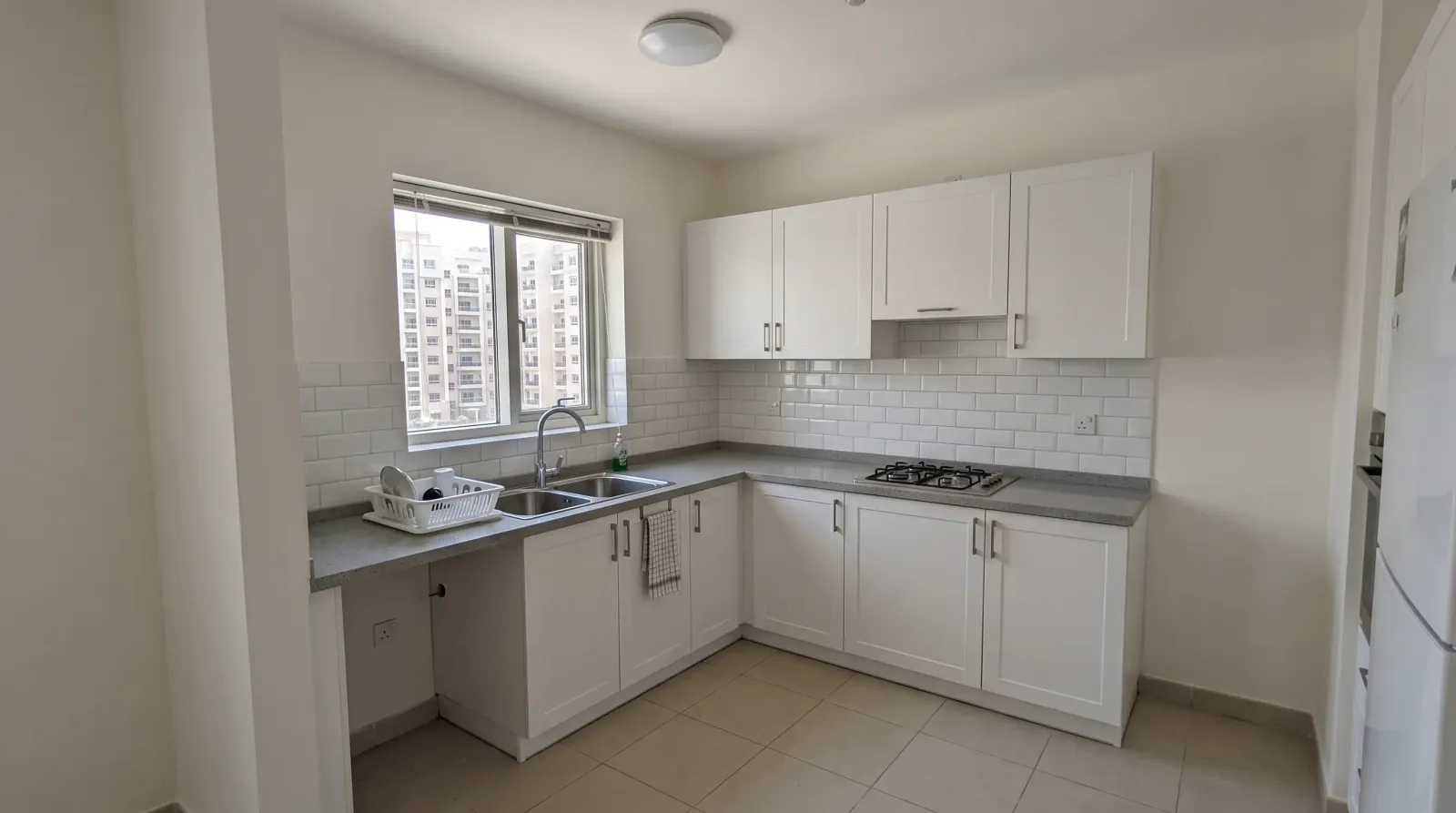 Apartment kitchen in Dubai repainted with cabinetry, ceiling and walls cut in cleanly
