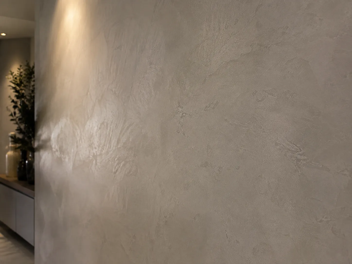 Microcement feature wall in a Dubai hallway showing subtle trowel character and tonal movement