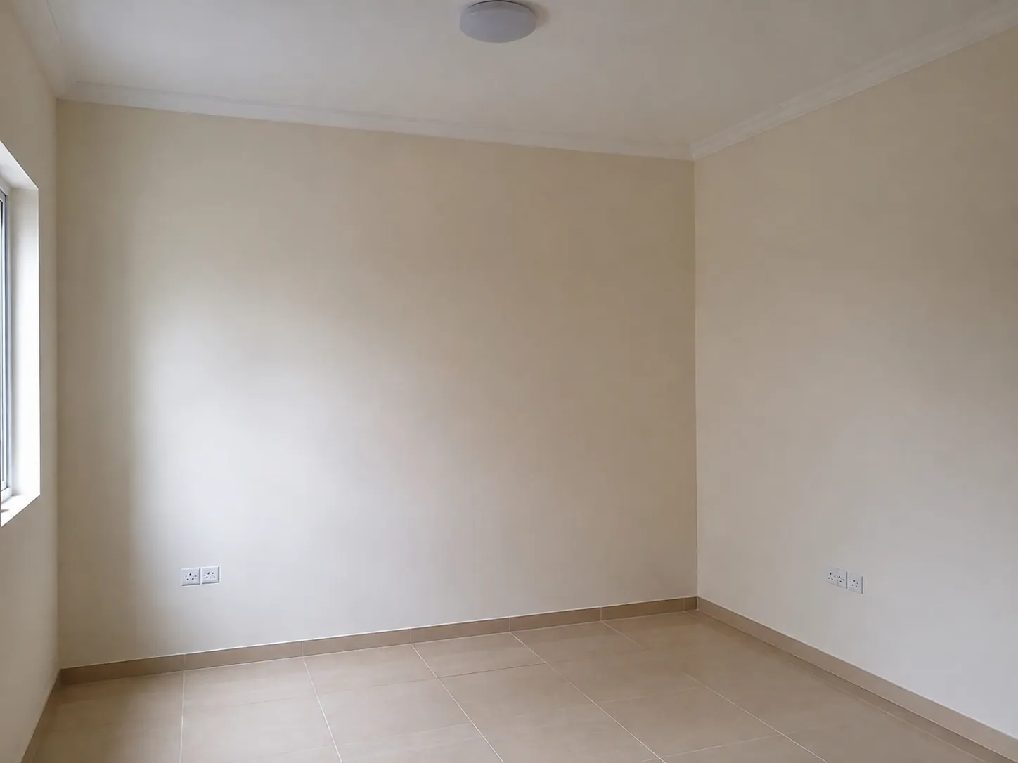 Empty Dubai apartment repainted to a uniform neutral before handover inspection